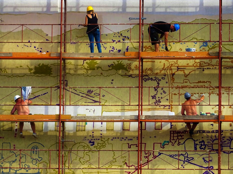 Men working while in a scaffolding